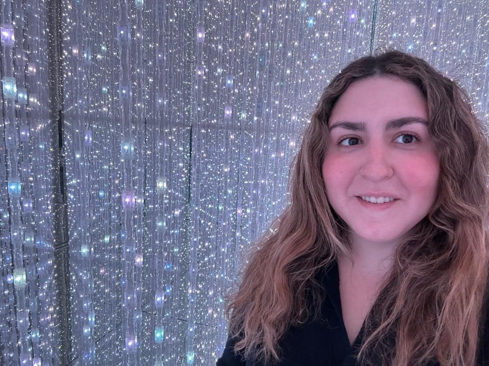 rachel dube in front of glittery wall of lights