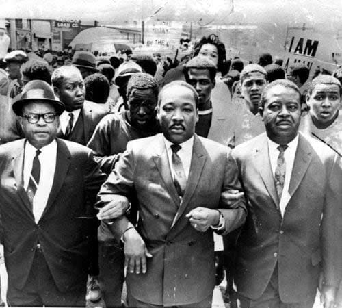Bishop B. Jlian Smith, of the Episcopal District of the Christian Methodist Church (left), King (center), and Rev. Ralph Abernathy (right) during a civil rights march in Memphis, Tenn. in 1968. (File photo/AP)
