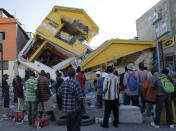 <p>People look at a destroyed building in Port-au-Prince, Haiti, Jan.14, 2010. (Photo: Jorge Silva/Reuters) </p>