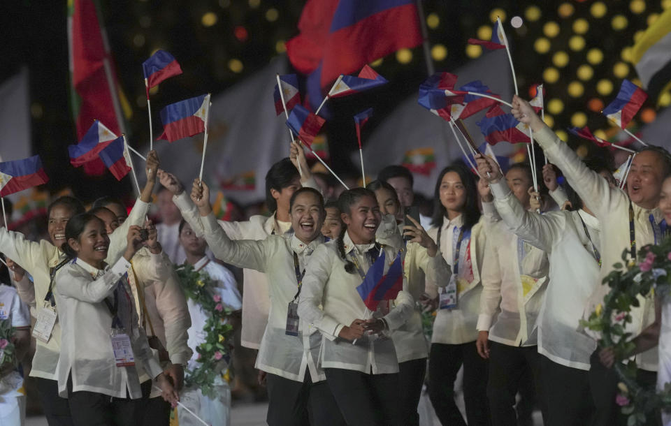 Philippine's team hold flags during the opening ceremony of the 32th South East Asian Games at the Morodok Techo National Stadium in Phnom Penh, Cambodia on Friday, May 5, 2023. (AP Photo/Tatan Syuflana)