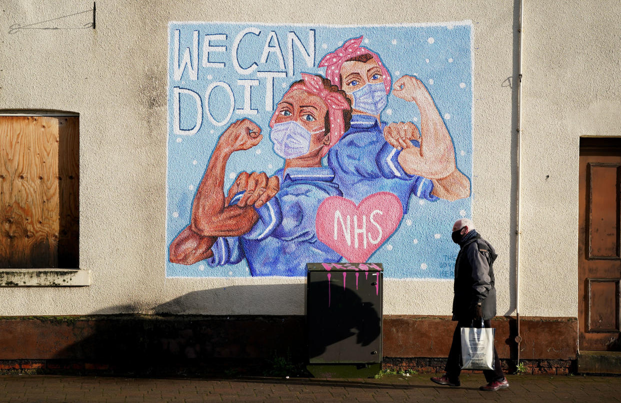 <p>A man walks past an NHS Mural in Loughborough, Leicestershire, during England’s third national lockdown</p> (PA)