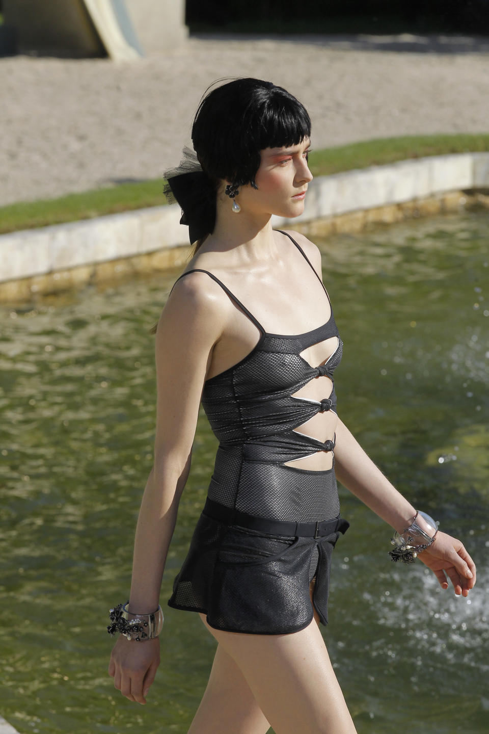 A model presents a creation by German fashion designer Karl lagerfeld for Chanel, Monday, May, 14, 2012. Master of Fashion, Karl Lagerfeld spares no expenses for his midseason Chanel Cruise show offering held at the former home of Marie Antoinette, the Chateau de Versailles, southwest of Paris. (AP Photo/Jacques Brinon)