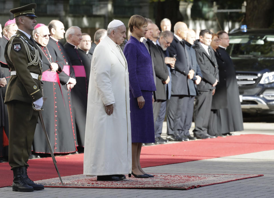 Pope Francis, left, and President of Estonia Kersti Kaljulaid, review the honor guard during the welcome ceremony at the Kadriorg Presidential Palace, Estonia, Tuesday, Sept. 25, 2018. Pope Francis concludes his four-day tour of the Baltics visiting Estonia. (AP Photo/Andrew Medichini)