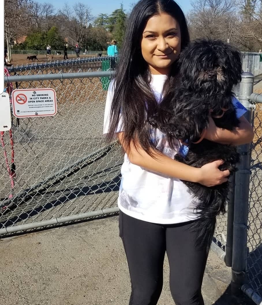 Elizabeth holding her pup outside