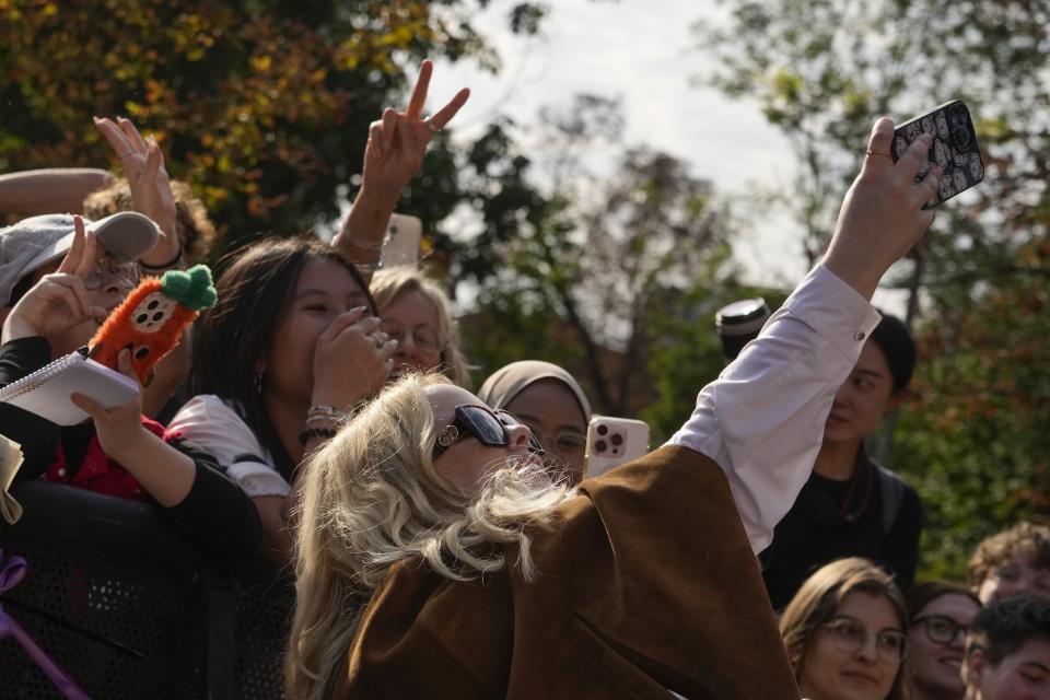 Nicola Coughlan takes photographs with fans as she departs the Gucci Spring Summer 2025 collection, that was presented in Milan, Italy, Friday, Sept. 20, 2024. (AP Photo/Luca Bruno).