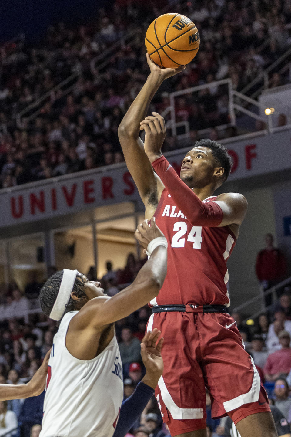 Alabama forward Brandon Miller (24) shoots over South Alabama guard Greg Parham II (2) during the first half of an NCAA college basketball game, Tuesday, Nov. 15, 2022, in Mobile, Ala. (AP Photo/Vasha Hunt)