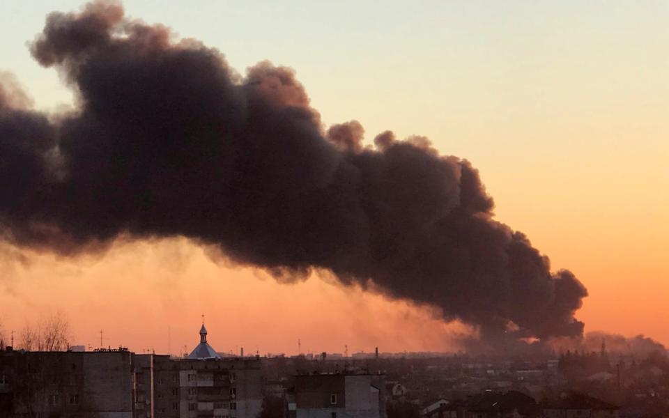 A cloud of smoke raises after an explosion in Lviv, western Ukraine, Friday, March 18, 2022. The mayor of Lviv says missiles struck near the city's airport early Friday. (AP Photo)  - AO