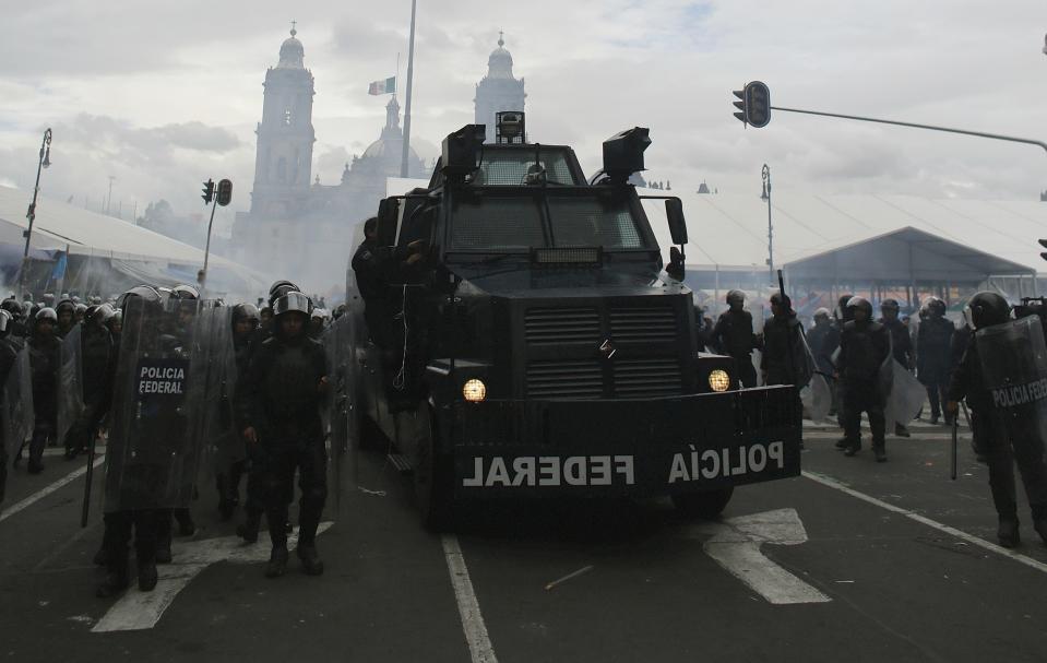 Federal riot police officers are deployed alongside a riot truck after striking members of the teachers' union CNTE were evicted from Zocalo Square in downtown Mexico City September 13, 2013. (REUTERS/Tomas Bravo)