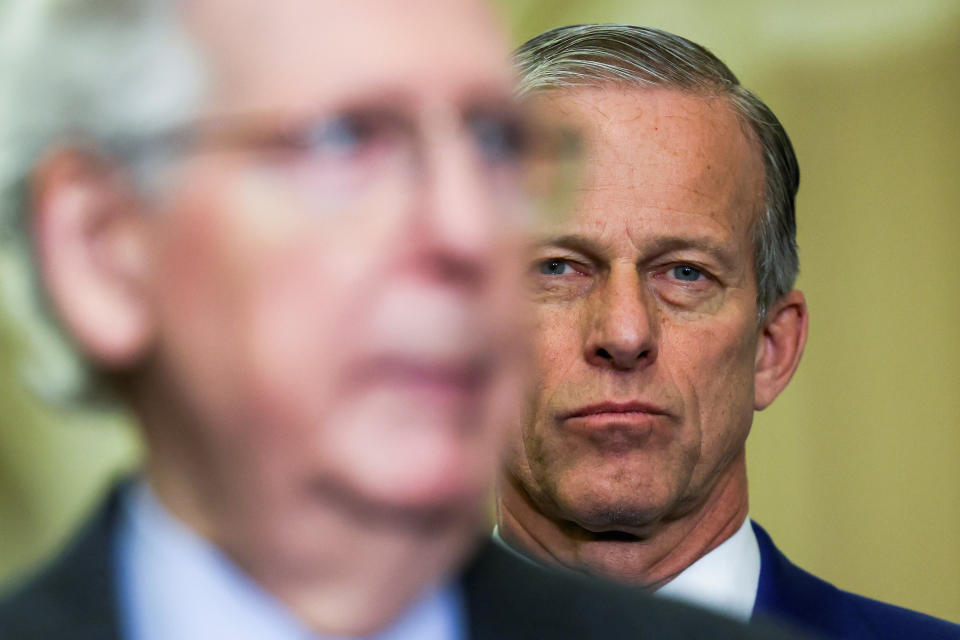 Senate Minority Leader Mitch McConnell (R-KY) speaks as U.S. Senator John Thune (R-SD) looks over his shoulder during a press conference following the weekly Republican caucus lunches of the Senate on Capitol Hill in Washington, U.S., March 20, 2024. REUTERS/Amanda Andrade-Rhoades