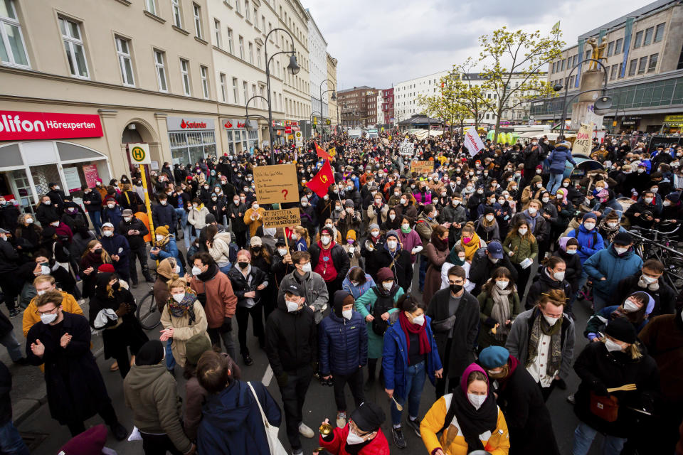 Participants gather for a mass rally to protest against a court ruling removing a rent cap in Berlin, Germany Thursday April 15, 2021. The alliance "Together against displacement and #Mietenwahnsinn" gathered Thursday to protest after the court overturned the rent cap. (Christoph Soeder/dpa via AP)