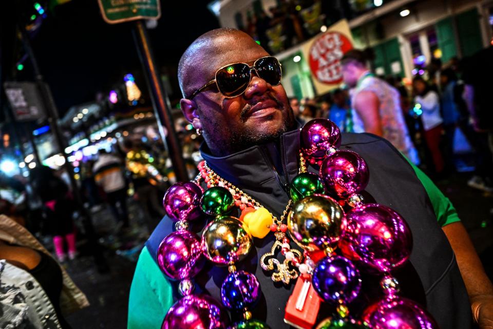 A reveler wears beads while walking in the French Quarter during a Mardi Gras celebration in New Orleans, Louisiana, on Feb. 19, 2023.