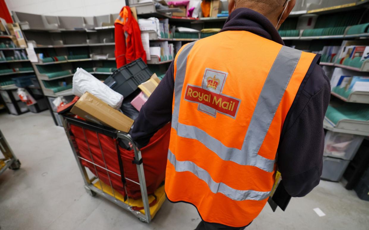 An employee pulls a trolley through the Royal Mail Plc sorting office in Chelmsford, U.K., on Thursday, May 13, 2021. - Chris Ratcliffe/ Bloomberg