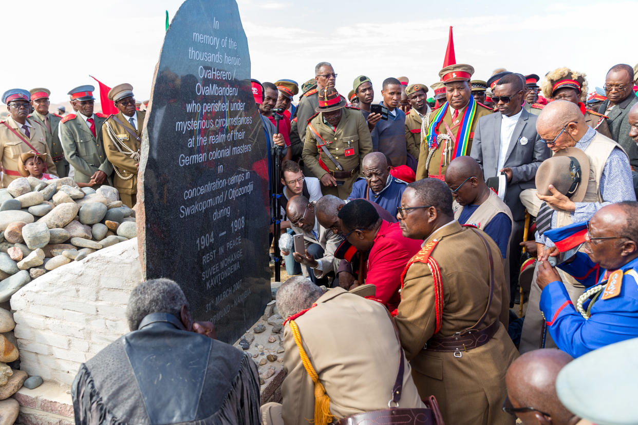 Paramount Chief Adv. Vekuii Rukoro, high-ranked chiefs and other members of the Herero and Nama communities gather around a monument in honor of the Ovaherero and Nama people that were victims of the genocide by German colonial forces at the Swakopmund Concentration Camp Memorial, in Swakopmund, Namibia, as a part of the Reparation Walk 2019 on March 30, 2019.