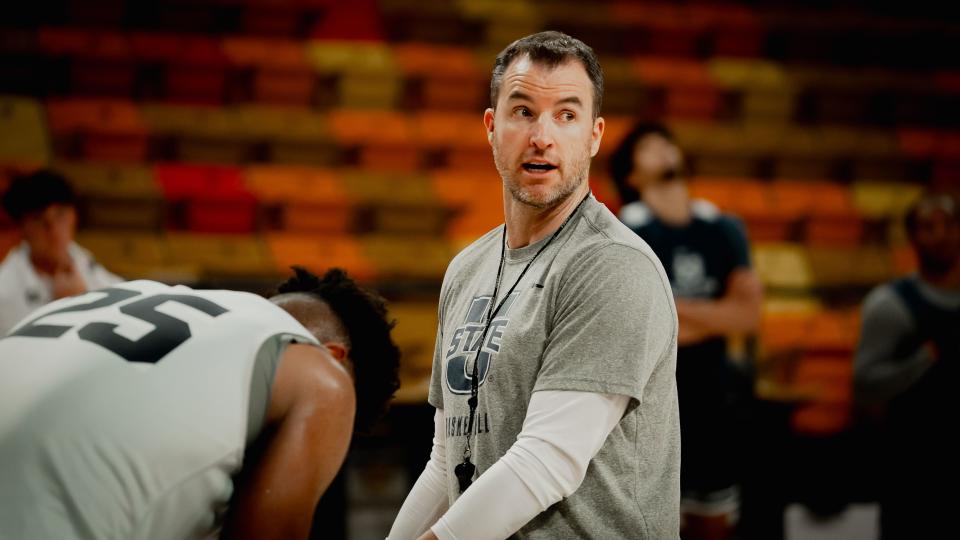 First-year Utah State Aggie coach Danny Sprinkle coaches up his team during a workout in the Smith Spectrum in Logan. | Utah State Athletics