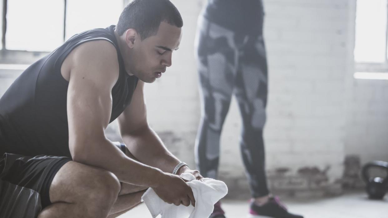 athletes resting with towel