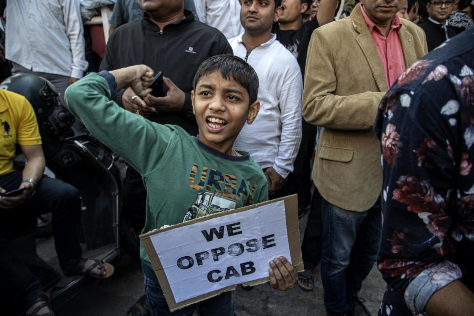 An Indian boy joins in a protest rally during a shutdown against the Citizenship Amendment Bill (CAB) in Gauhati, India, Tuesday, Dec. 10, 2019. Opponents of legislation that would grant Indian citizenship to non-Muslim illegal migrants from Pakistan, Bangladesh and Afghanistan have enforced an 11-hour shutdown across India's northeastern region. (AP Photo/Anupam Nath)