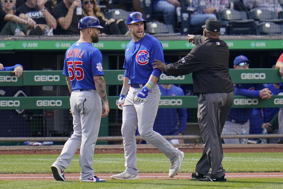 Chicago Cubs' Patrick Wisdom, center, has words for Pittsburgh Pirates relief pitcher Duane Underwood Jr. as he walks to first base after being hit by a pitch during the seventh inning of a baseball game in Pittsburgh, Sunday, Sept. 25, 2022. (AP Photo/Gene J. Puskar)