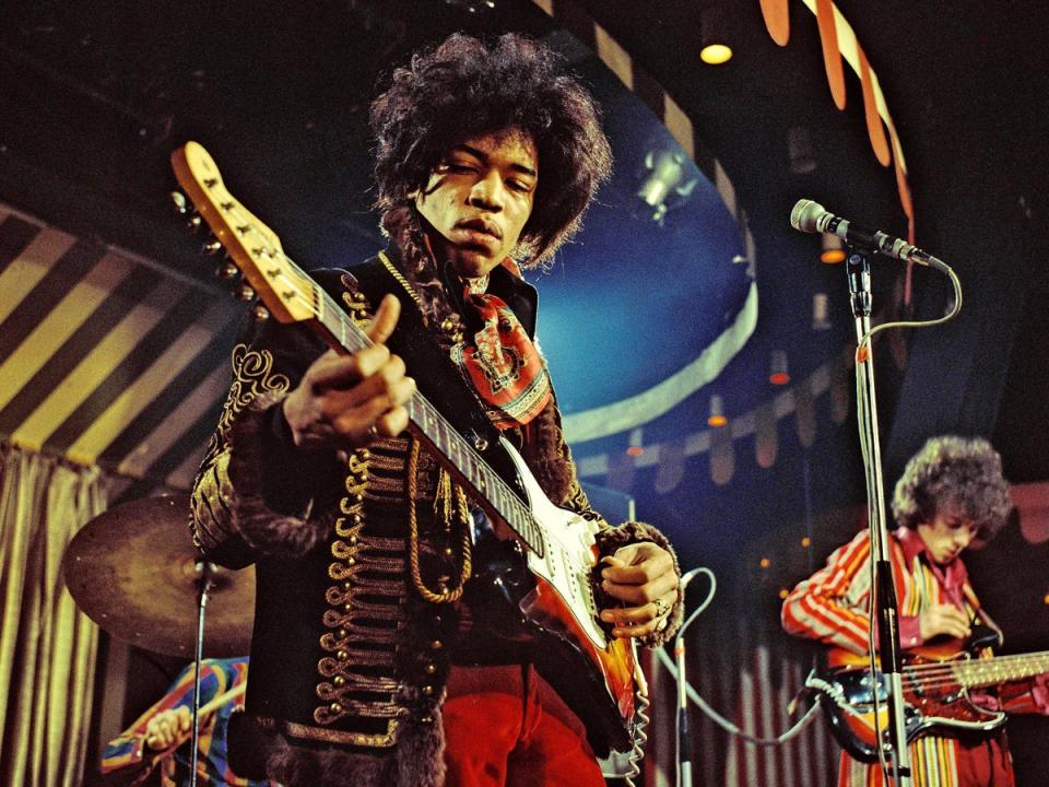 Jimi Hendrix (left) and Noel Redding play with The Jimi Hendrix Experience at the Marquee Club in London, 1967 (Marc Sharratt/Shutterstock)