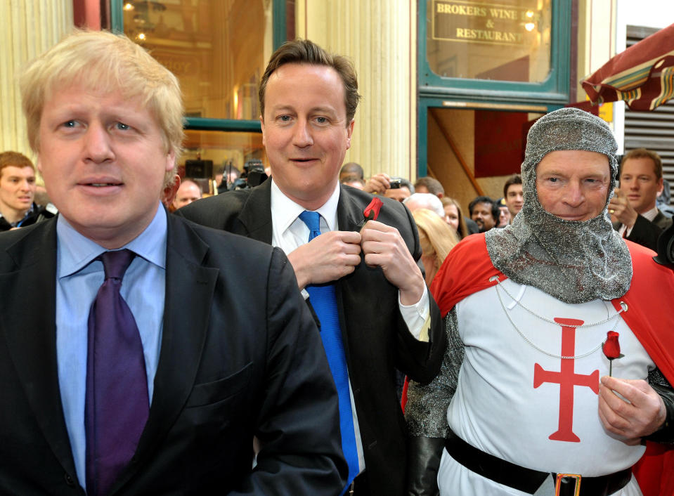 Leader of the Conservative Party David Cameron (centre) with Mayor of London Boris Johnson (left) as they celebrate St George's day in Leadenhall Market in the City of London.