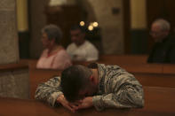 <p>Air Force Captain Emmanuel Rivera prays during the opening Mass of the Presbyteral Convocation at San Fernando Cathedral in San Antonio, Texas on Monday, Nov. 6, 2017. Special prayers were said and a display of candles memorialized the victims of the mass shooting at First Baptist Church in Sutherland Springs during the mass. (Photo: San Antonio Express-News via ZUMA Wire) </p>