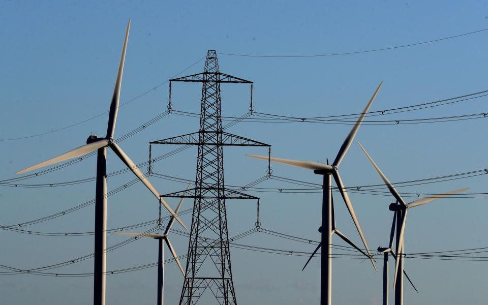 Wind farm amongst electricity pylons