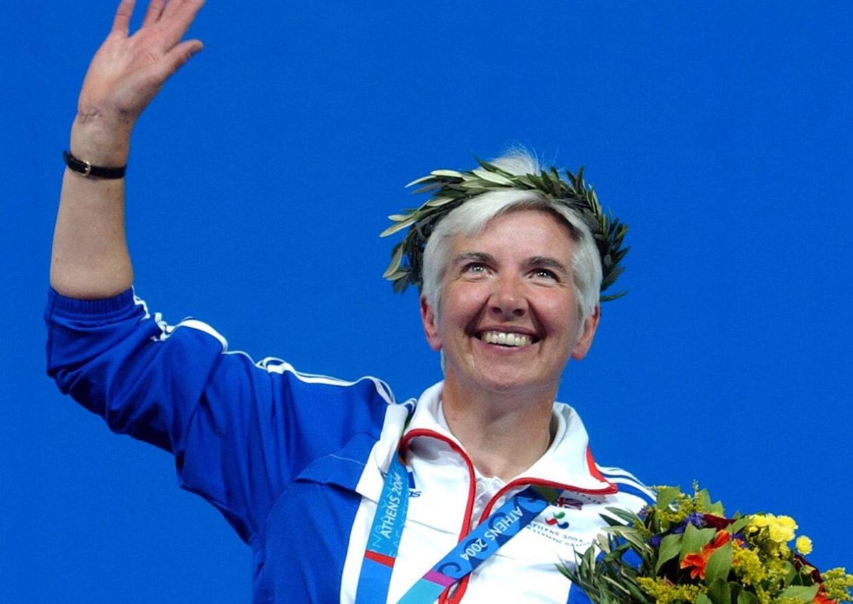 Britain's Isabel Newstead waves to the crowd with her gold medal after the 10m Air Pistol SH1 final at the Athens 2004 Paralympic Games in the Olympic Shooting Center on Sunday, Sept. 19, 2004. (AP Photo/Thanassis Stavrakis)