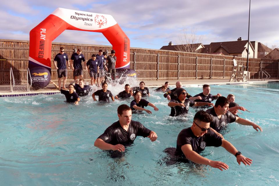 Students from the Amarillo Police Academy get cold and wet in the annual Special Olympics Polar Plunge held at Amarillo Town Club on Hillside Saturday morning.