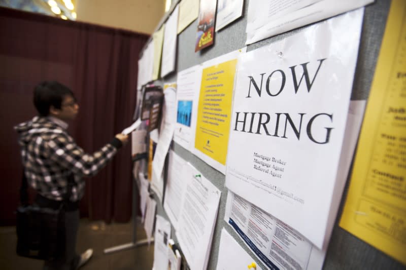 A man looks at a job board posted at a job fair in Toronto, April 1, 2009. REUTERS/Mark Blinch (CANADA BUSINESS) - RTXDID0