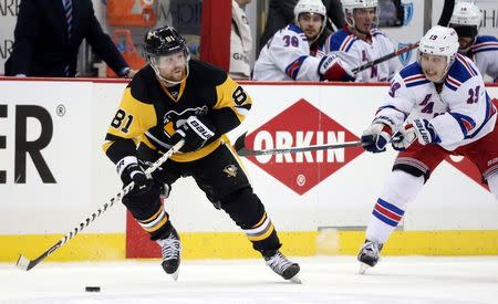 Pittsburgh Penguins right wing Phil Kessel (81) handles the puck against pressure from New York Rangers right wing Jesper Fast (19) during the third period in game two of the first round of the 2016 Stanley Cup Playoffs at the CONSOL Energy Center. The Rangers won 4-2. Mandatory Credit: Charles LeClaire-USA TODAY Sports