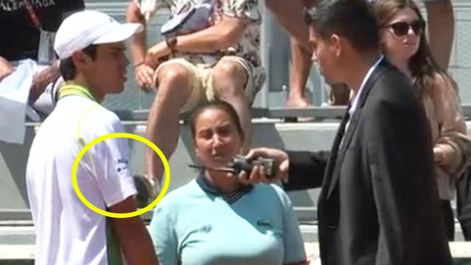 The court supervisor tells Rodrigo Pacheco to change his shirt at the French Open.