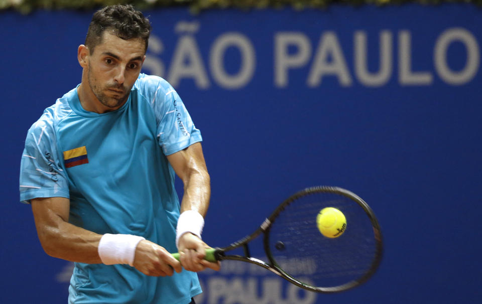 Colombia's Santiago Giraldo returns the ball to Brazil's Thomaz Bellucci at the Brazil Open ATP tournament tennis match in Sao Paulo, Brazil, Tuesday, Feb. 25, 2014. (AP Photo/Andre Penner)