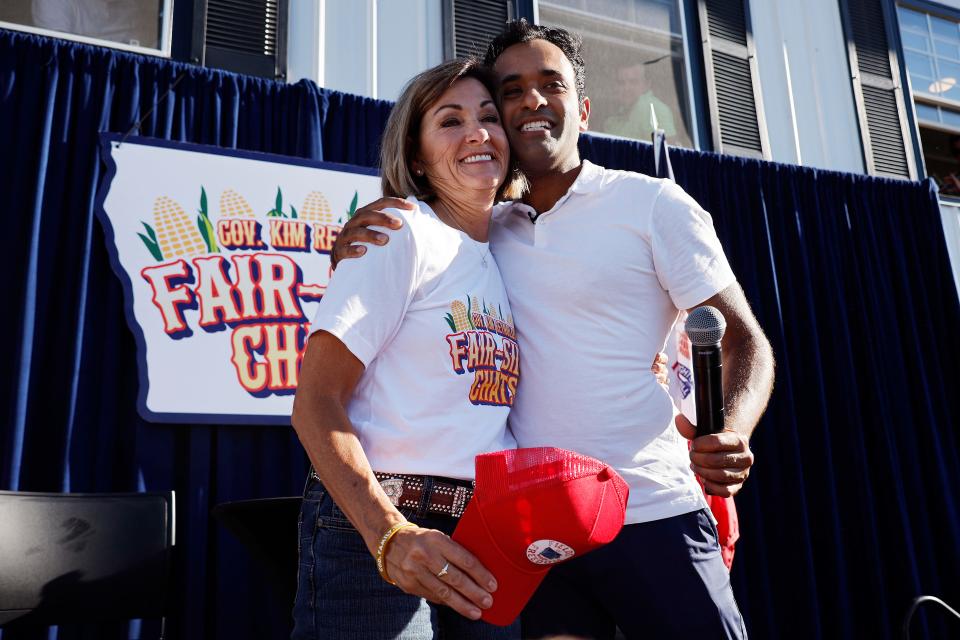 DES MOINES, IOWA - AUGUST 12: Biotech millionaire and Republican presidential candidate Vivek Ramaswamy embraces Iowa Governor Kim Reynolds at the conclusion of one of her "Fair-Side Chats" at the Iowa State Fair on August 12, 2023 in Des Moines, Iowa. Republican and Democratic presidential hopefuls are visiting the fair, a tradition in one of the first states that will test candidates with the 2024 caucuses.