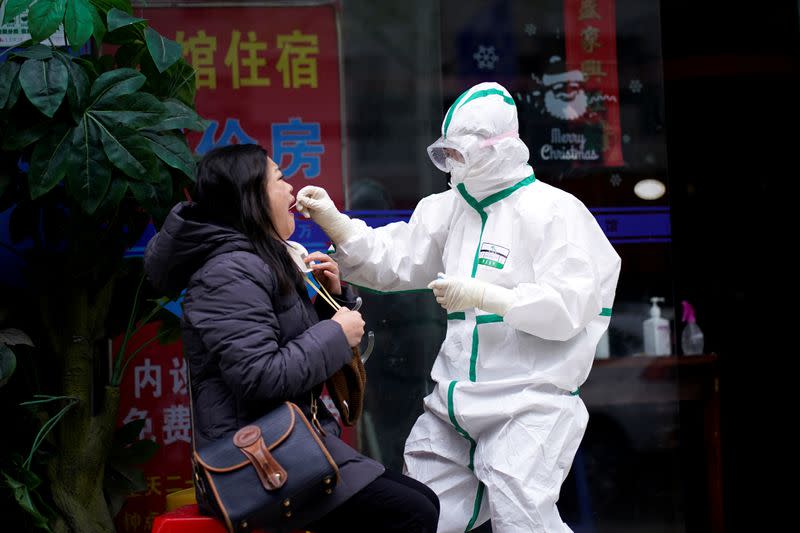 FILE PHOTO: Reuters reporter Brenda Goh receives a nucleic acid test for COVID-19 in Wuhan