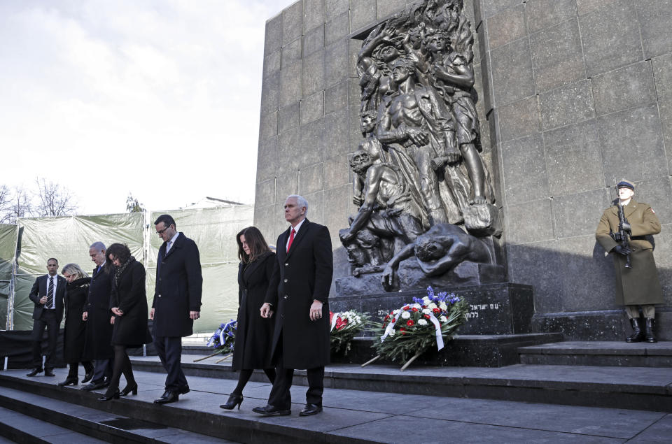 United States Vice President Mike Pence with his wife Karen, Prime Minister of Poland Mateusz Morawiecki with his wife Iwona and Israeli Prime Minister Benjamin Netanyahu with his wife Sara, from right, leave the Monument to the Ghetto Heroes during a wreath laying ceremony in Warsaw, Poland, Thursday, Feb. 14, 2019. The Polish capital is host for a two-day international conference on the Middle East, co-organized by Poland and the United States. (AP Photo/Michael Sohn)