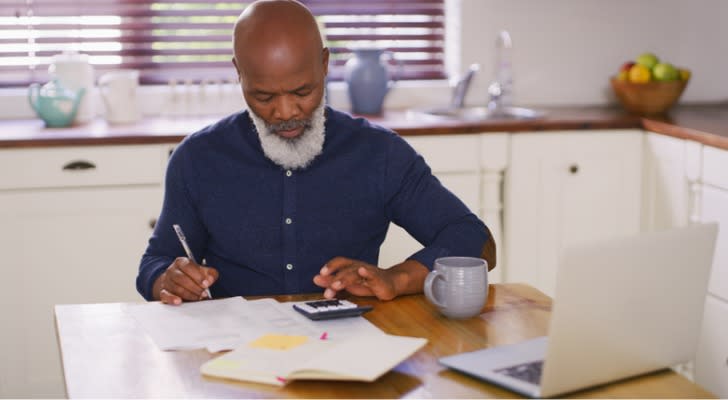 A man calculating his tax obligation on $1 million