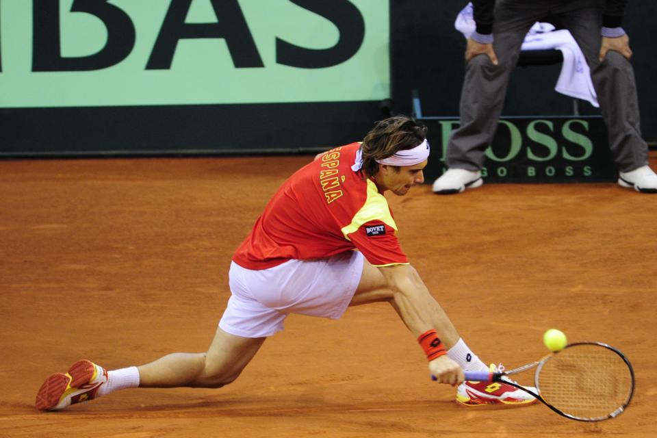 Spanish David Ferrer returns a ball to Argentinian Juan Martin Del Potro during the Davis Cup final second match at La Cartuja Olympic stadium in Sevilla on December 2, 2011.  AFP PHOTO / JAVIER SORIANO (Photo credit should read JAVIER SORIANO/AFP/Getty Images)