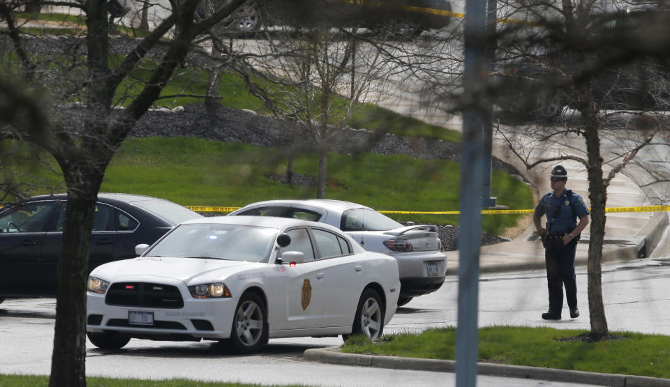 A Kansas State Trooper stands near the location of a shooting at the Jewish Community Center in Overland Park, Kan., Sunday, April 13, 2014. (AP Photo/Orlin Wagner)