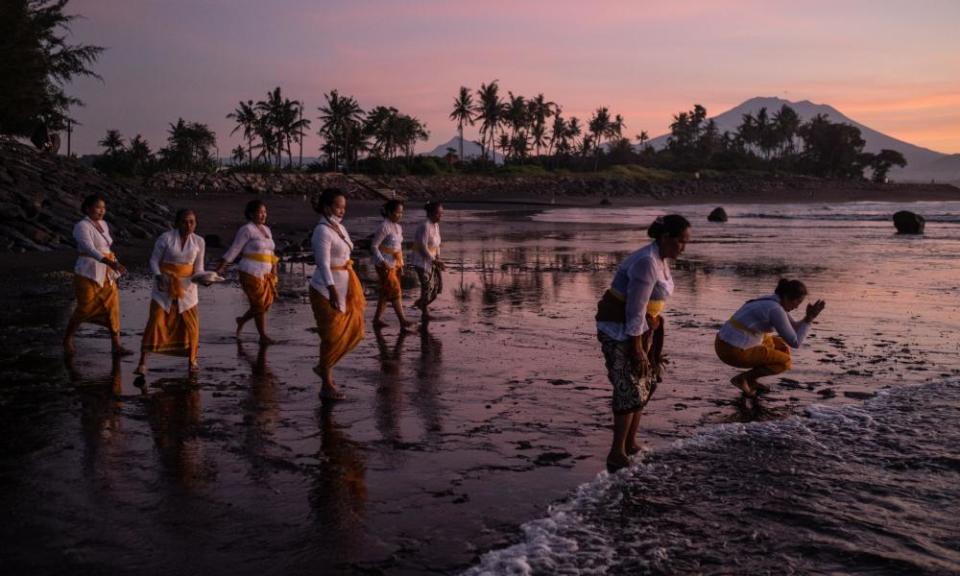 Balinese women clean themselves during the Melasti ritual in the run up to Nyepi