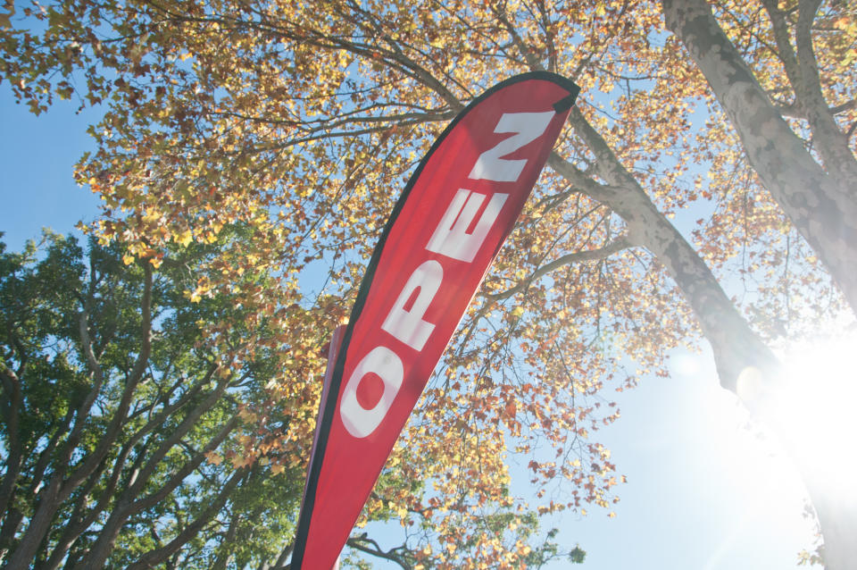 Red Open House for Sale/Rent signage in Autumn