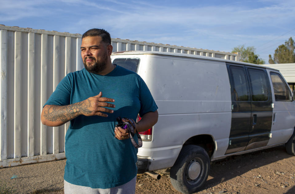 Venezuelan asylum-seeker Luis Lopez shows the van he's refurbishing to be ready for when he gets his work permit start a house-painting and remodeling business in El Paso, Texas, Friday, May 12, 2023. When Lopez was lost in Panama's Darien Gap last year with his pregnant wife, their two children and her grandmother, he often knelt in the mud to beg God not to abandon them. (AP Photo/Andres Leighton)