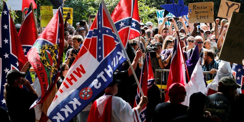 FILE PHOTO: Members of the Ku Klux Klan face counter-protesters as they rally in support of Confederate monuments in Charlottesville, Virginia, U.S. on July 8, 2017. REUTERS/Jonathan Ernst/File Photo