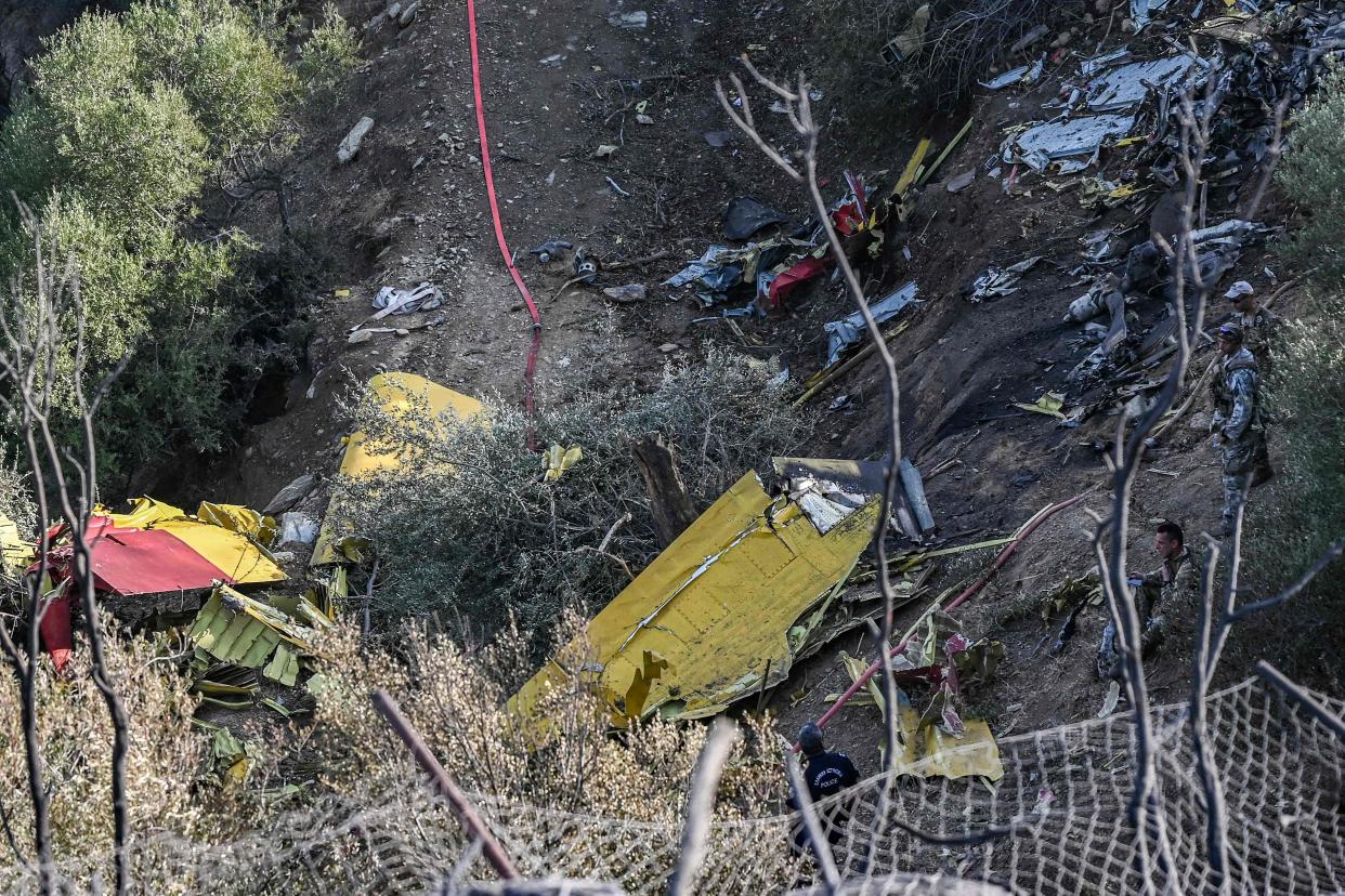 Debris of a Canadair CL-215 firefighting aircraft, which crashed near while being flown to fight a wildfire in Karystos, on the Greek Aegean island of Evia, on July 25, 2023. Two pilots died when their water-bombing plane crashed while battling a blaze on the Greek island of Evia (AFP/Getty)