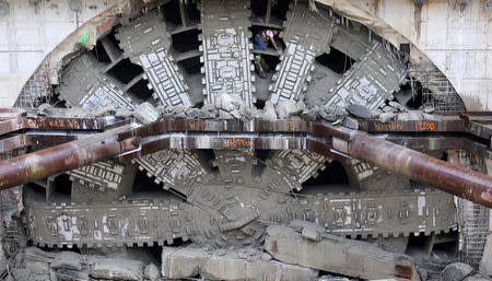 Workers celebrate by posing inside the giant teeth of Seattle’s tunnel-drilling machine, Bertha, the world's largest tunnel-boring machine at its completion into the disassembly pit in Seattle, Washington, U.S., April 4, 2017. REUTERS/Karen Ducey