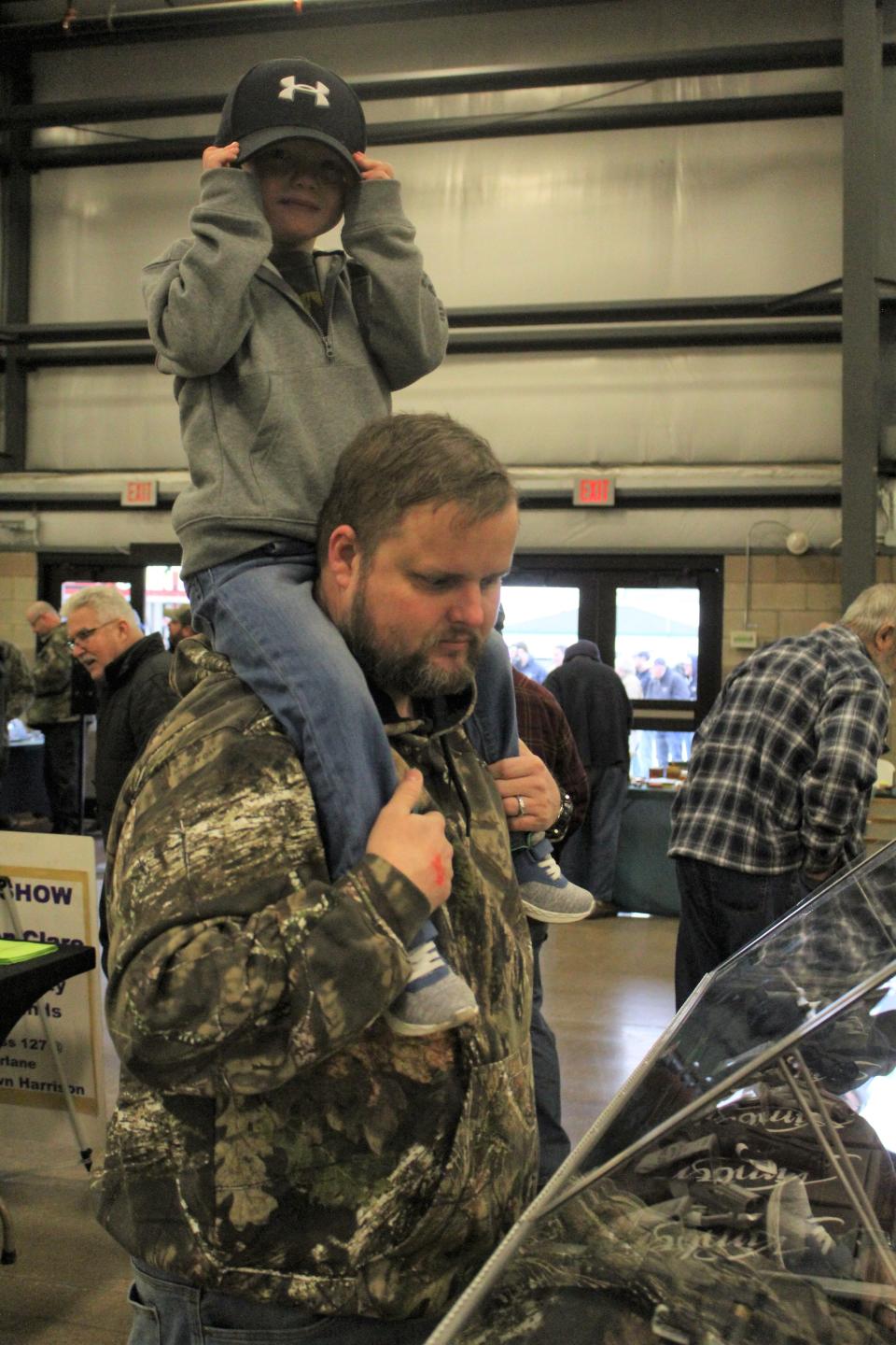 Monroe resident William Muncy and his three-year-old son, Lincoln, spent Saturday morning walking around and looking at things at the Monroe Gun & Knife Show.