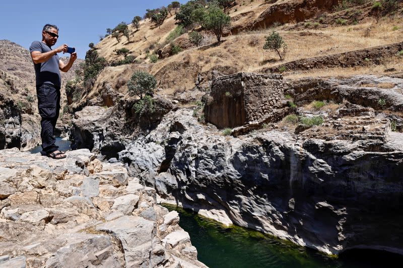 Nabil Musa, an Iraqi Kurdish environmental activist, takes pictures of Sirwan River on the outskirt of Halabja