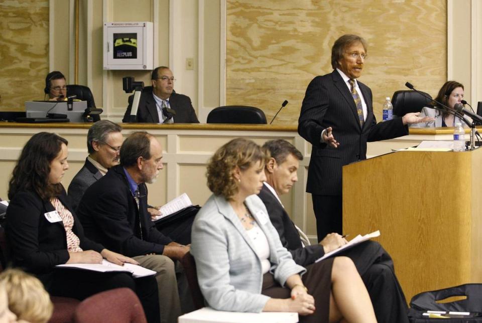 Bruce Simpson, (right, standing) attorney for Kroger, speaks during a public hearing by the urban county council to discuss the proposed Kroger redevelopment in Lexington, Ky., Tuesday, August 13, 2013. Photo by Matt Goins