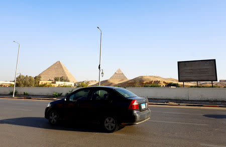 FILE PHOTO: A car drives past pyramids near the site of a blast which damaged a bus near a new museum being built close to the Giza pyramids in Cairo, Egypt, May 19, 2019. REUTERS/Amr Abdallah Dalsh/File Photo
