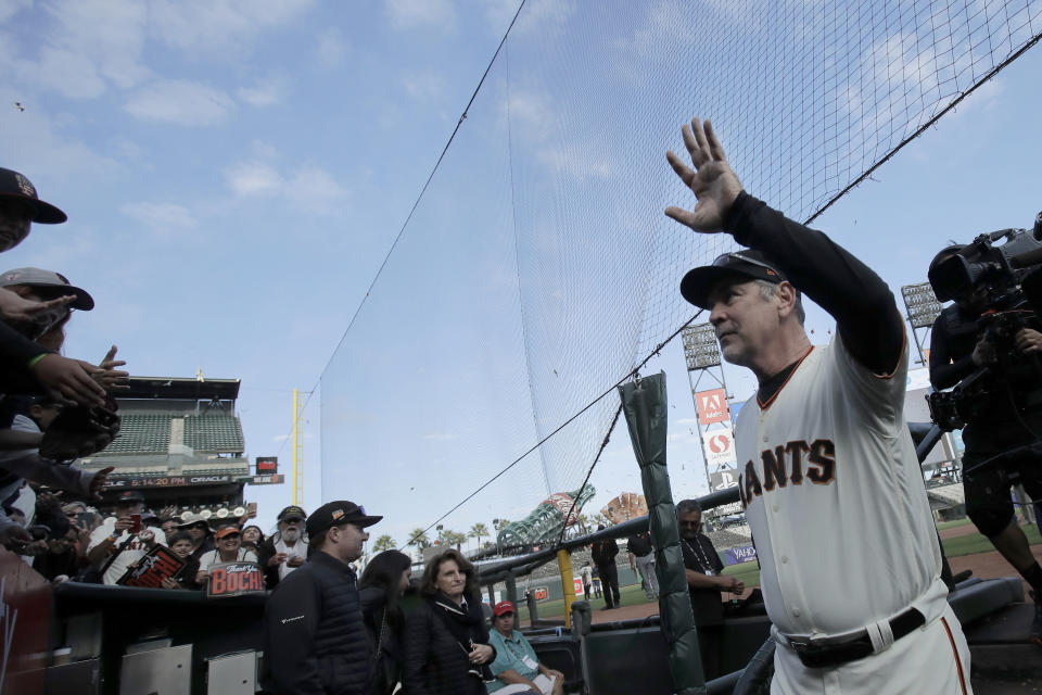 San Francisco Giants manager Bruce Bochy waves to fans as he exits the field during a ceremony honoring Bochy after a baseball game between the Giants and the Los Angeles Dodgers in San Francisco, Sunday, Sept. 29, 2019. (AP Photo/Jeff Chiu, Pool)