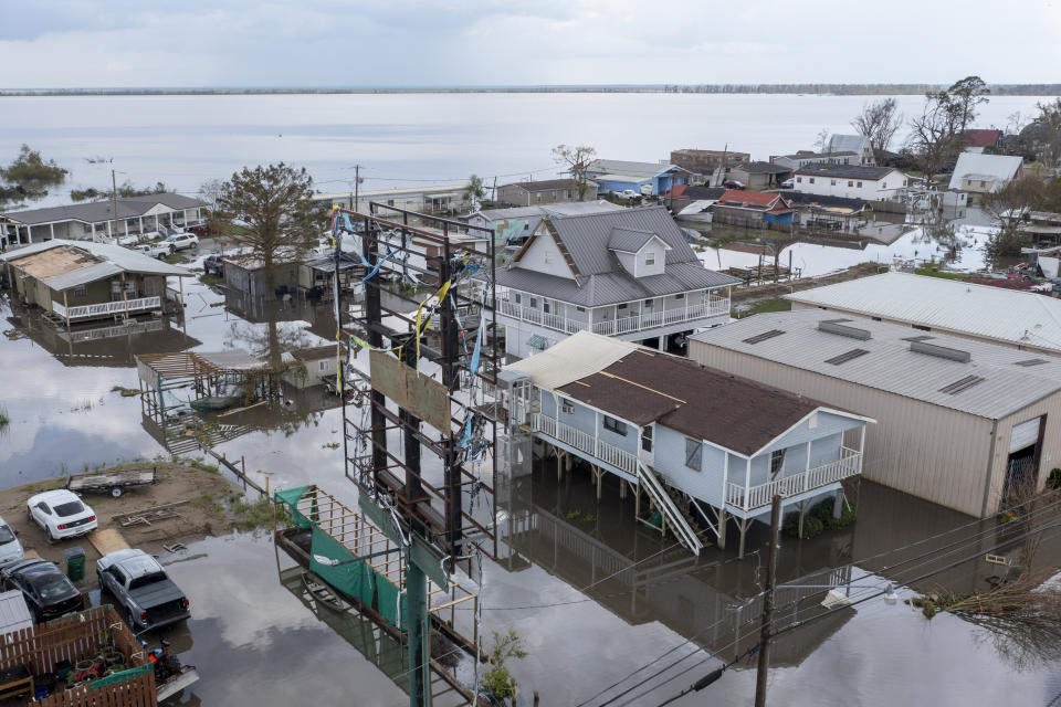 FILE - Flood waters surround storm damaged homes on Aug. 31, 2021, in Lafourche Parish, La., as residents try to recover from the effects of Hurricane Ida. FEMA announced Friday, Jan. 19, 2024, it is making changes to its program that helps those who survive wildfires, hurricanes and other natural disasters. The changes are designed to simplify and speed up the process for disaster survivors to get help, including include money for under-insured homeowners, a streamlined application process, and assistance for disaster survivors with disabilities. (AP Photo/Steve Helber)