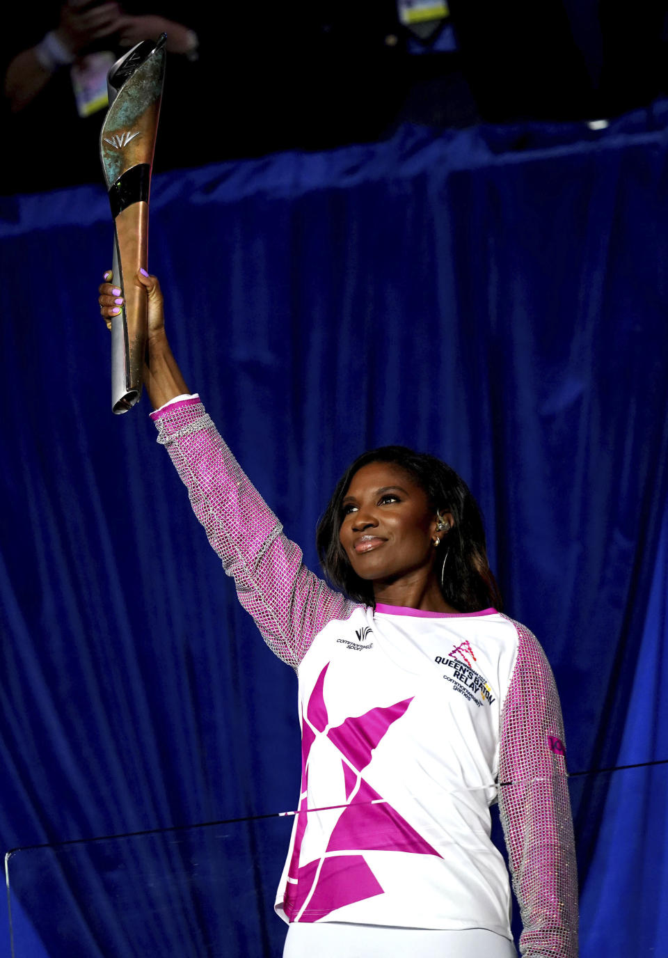 Denise Lewis OBE carries the baton during the opening ceremony of the Commonwealth Games at the Alexander Stadium, in Birmingham, England, Thursday July 28, 2022. (David Davies/PA via AP)